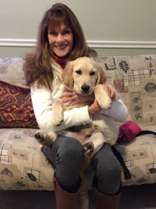 Ann with her adorable 16-week old client, Riley.