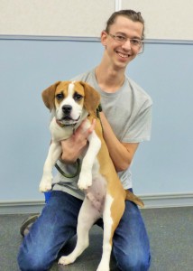 Greg posing with Burke, one of the many shelter dogs he helped to train while attending CATCH On-Campus at St. Hubert's.